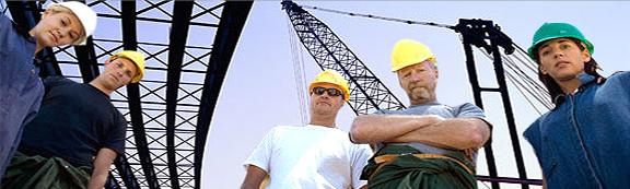 Group of Port workers standing under large cranes
